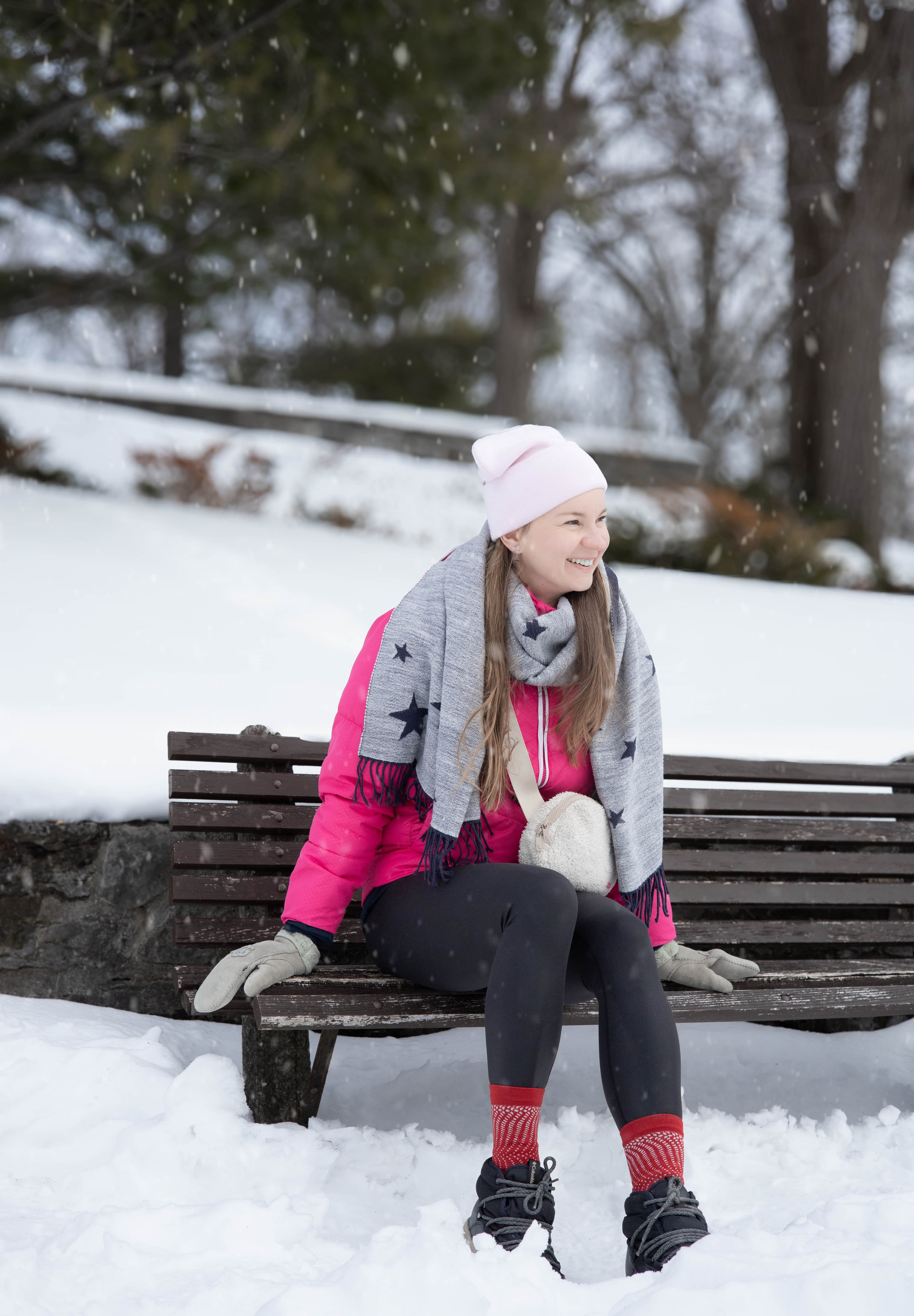 Woman in colorful winter coat and earmuffs
