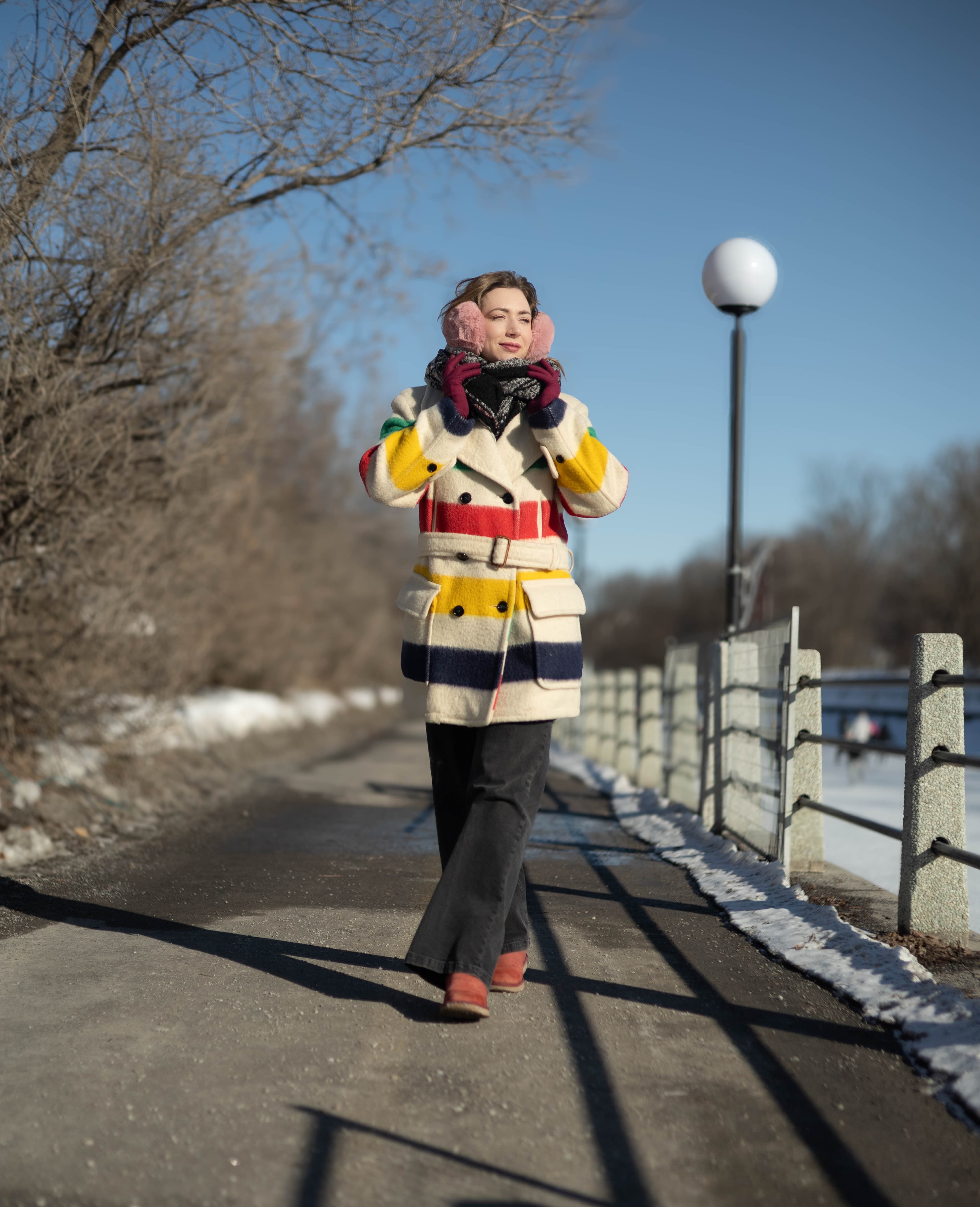 Full-body winter portrait in striped coat